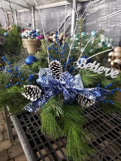 A fresh evergreen Christmas container with red accents